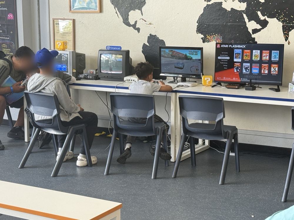 Players at a row of retro gaming screens