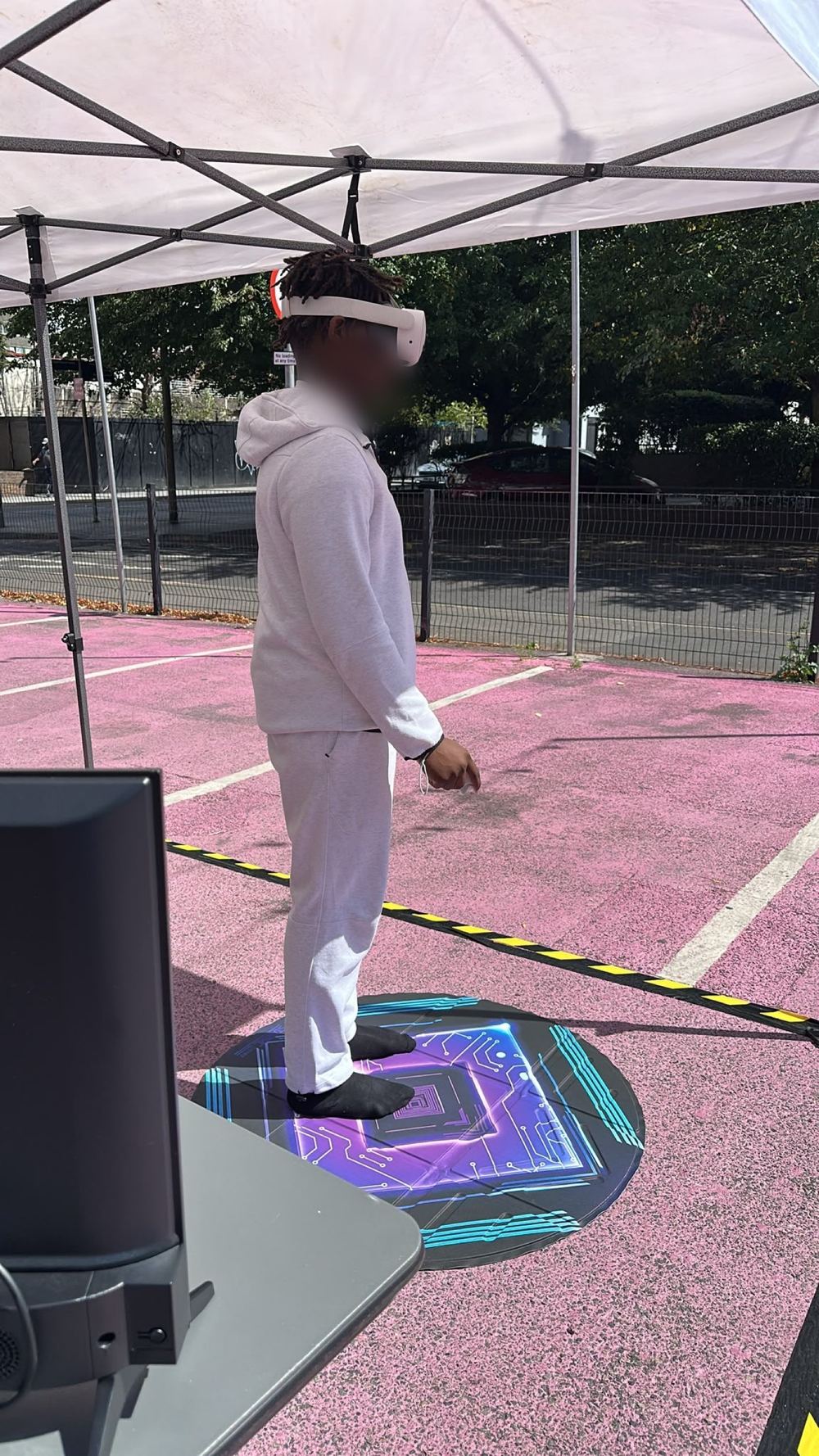 A guest wearing a VR headset on an outdoor play area